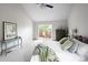 Bright main bedroom featuring a private deck, vaulted ceiling, neutral color palette and green accents at 10572 E Orchard Pl, Englewood, CO 80111
