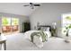 Bright main bedroom featuring a private deck, vaulted ceiling and a ceiling fan at 10572 E Orchard Pl, Englewood, CO 80111