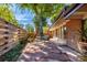 Charming back patio with stone pavers, a cozy dining set, and lush green surroundings at 1313 E Cornell Ave, Englewood, CO 80113