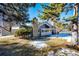 Rear view of house showing stone chimney and landscaping at 14393 E Marina Dr, Aurora, CO 80014