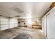 Spacious two-car garage with shelving and workbench at 14393 E Marina Dr, Aurora, CO 80014