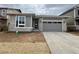 Charming single-story home with stone and gray siding, a concrete driveway, and an attached two-car garage at 24738 E 40Th Ave, Aurora, CO 80019