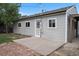 Backyard featuring a gray home, concrete patio, and brick accent, perfect for outdoor relaxation at 2735 S Dahlia St, Denver, CO 80222