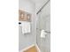 Bright bathroom featuring a glass shower door, white subway tiles, and framed fern prints at 2735 S Dahlia St, Denver, CO 80222