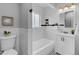 Stylish bathroom featuring black and white tile, a bathtub, and a white sink at 2735 S Dahlia St, Denver, CO 80222