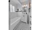 Stylish bathroom featuring black and white tile, a bathtub, and a modern white sink at 2735 S Dahlia St, Denver, CO 80222