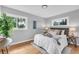 Inviting bedroom with natural light, hardwood floors, and a comfortably styled queen-size bed at 2735 S Dahlia St, Denver, CO 80222