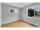 Empty bedroom featuring natural light from two windows and hardwood floors at 2735 S Dahlia St, Denver, CO 80222