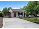 Charming single-story home featuring a red door, covered parking, and a well-maintained front yard at 2735 S Dahlia St, Denver, CO 80222