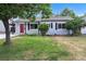 Charming home with a red front door, well-maintained lawn, and inviting curb appeal at 2735 S Dahlia St, Denver, CO 80222