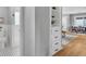 Hallway featuring a built in bookcase and a view of the tiled bathroom and dining area at 2735 S Dahlia St, Denver, CO 80222
