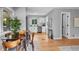 Open-concept kitchen with a dining area, stainless steel appliances, and modern white cabinets at 2735 S Dahlia St, Denver, CO 80222