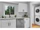 Bright kitchen featuring stainless steel appliances, white cabinets, and stone countertops at 2735 S Dahlia St, Denver, CO 80222