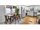 Open-concept kitchen with a dining area, stainless steel appliances, and modern white cabinets at 2735 S Dahlia St, Denver, CO 80222