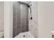 Modern shower with gray and white marble tile at 8140 Washington St # 135, Denver, CO 80229