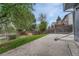 A serene backyard featuring a wooden fence, patio, bench, and lush greenery at 19140 E Milan Cir, Aurora, CO 80013