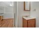 Attached bathroom with sink and vanity area, next to a room with wood-look floors at 19140 E Milan Cir, Aurora, CO 80013