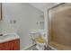 Bathroom featuring a standing shower, toilet, storage shelves and white porcelain sink at 19140 E Milan Cir, Aurora, CO 80013