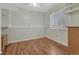 Bright bedroom features wood-look flooring, a ceiling fan, a window with blinds, and shelving at 19140 E Milan Cir, Aurora, CO 80013