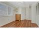 This bedroom boasts wood-look flooring, bright natural light, and a four-drawer dresser at 19140 E Milan Cir, Aurora, CO 80013