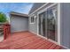 Outdoor deck features red wood, blue siding, and a sliding glass door entrance at 19140 E Milan Cir, Aurora, CO 80013