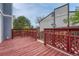 Outdoor deck features red wood, red railing, and a great view of neighboring buildings at 19140 E Milan Cir, Aurora, CO 80013