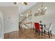 Charming dining area with hardwood floors, a modern chandelier, and a staircase in the background at 19140 E Milan Cir, Aurora, CO 80013