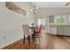 Bright dining area with hardwood floors, chandelier, and natural light from sliding glass door at 19140 E Milan Cir, Aurora, CO 80013