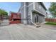 Exterior view showing a patio, red deck, sliding glass doors, gray paint, and concrete steps at 19140 E Milan Cir, Aurora, CO 80013