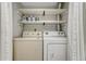 Laundry room featuring a side-by-side washer and dryer and convenient shelving at 19140 E Milan Cir, Aurora, CO 80013