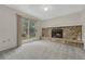 Carpeted living room with stone fireplace and sliding glass door to backyard at 19140 E Milan Cir, Aurora, CO 80013