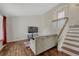Comfortable living room features wood floors, bright walls, a modern TV, and staircase at 19140 E Milan Cir, Aurora, CO 80013