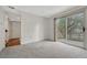 Carpeted living room with a large sliding glass door overlooking the backyard at 19140 E Milan Cir, Aurora, CO 80013