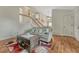 Cozy living room features hardwood floors, neutral color palette and a staircase leading to the second floor at 19140 E Milan Cir, Aurora, CO 80013