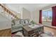 Comfortable living room with hardwood floors, sofa, staircase and a bright window at 19140 E Milan Cir, Aurora, CO 80013