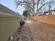 A backyard with wooden fence, landscaping, and mature tree shading a rustic patio area, perfect for enjoying the outdoors at 3482 S Eagle St # 102, Aurora, CO 80014