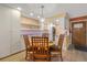 Charming dining area with pendant lighting and bar seating leading to a bright kitchen with granite countertops at 3482 S Eagle St # 102, Aurora, CO 80014