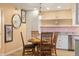 Charming dining area adjacent to the kitchen, featuring a stylish light fixture at 3482 S Eagle St # 102, Aurora, CO 80014