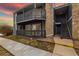 Charming condo with gray siding, stone accents, and covered balcony at 3482 S Eagle St # 102, Aurora, CO 80014