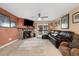 Cozy living room features a stone fireplace, a comfortable leather sectional, and balcony access for outdoor relaxation at 3482 S Eagle St # 102, Aurora, CO 80014