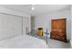 Bright bedroom features a full closet, an armoire, and a comfortable bed at 595 S Alton Way # 1C, Denver, CO 80247