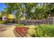 Stone community sign nestled among lush greenery and flowering plants at 595 S Alton Way # 1C, Denver, CO 80247