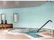 Indoor hot tub featuring stone accents and serene blue walls for a relaxing experience at 595 S Alton Way # 1C, Denver, CO 80247