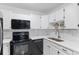 Well-lit kitchen featuring a stainless steel sink, modern appliances, and ample counter space at 595 S Alton Way # 1C, Denver, CO 80247