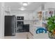 Bright kitchen with white cabinets, modern appliances, and adjacent dining area at 595 S Alton Way # 1C, Denver, CO 80247
