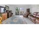 Bright living room with a sliding glass door to the outside, nice furniture and a beautiful area rug at 595 S Alton Way # 1C, Denver, CO 80247