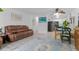 Spacious living area with open-concept design, comfortable sofa, and partial kitchen view at 595 S Alton Way # 1C, Denver, CO 80247