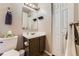 Compact bathroom with modern fixtures, vanity, and linen closet for storage at 330 N Wagonwheel Trl, Castle Rock, CO 80104