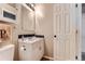 Bathroom with vanity, white cabinets, framed mirror, and a white door at 330 N Wagonwheel Trl, Castle Rock, CO 80104