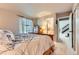 Bedroom with large window, chest of drawers, and ensuite bathroom access at 330 N Wagonwheel Trl, Castle Rock, CO 80104